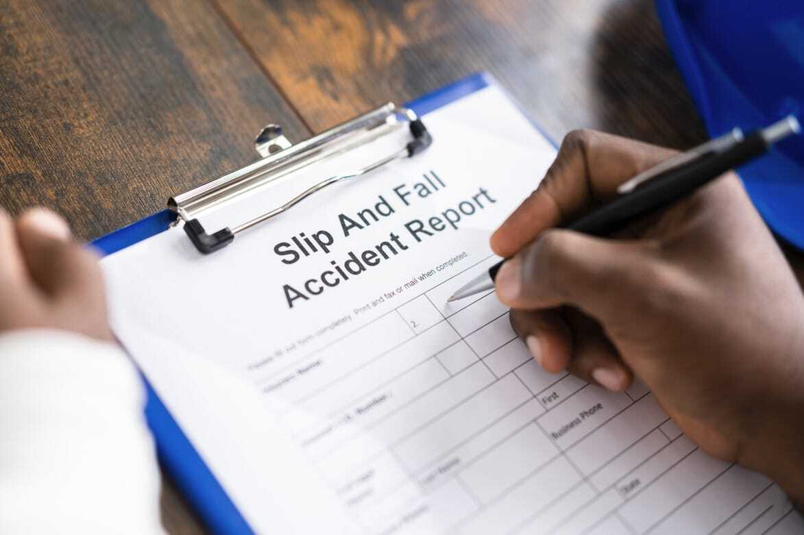 person filling out slip and fall accident report