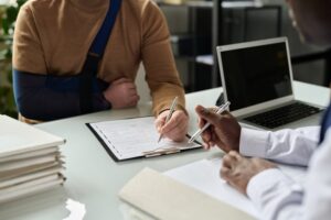 individual signing legal documents with attorney